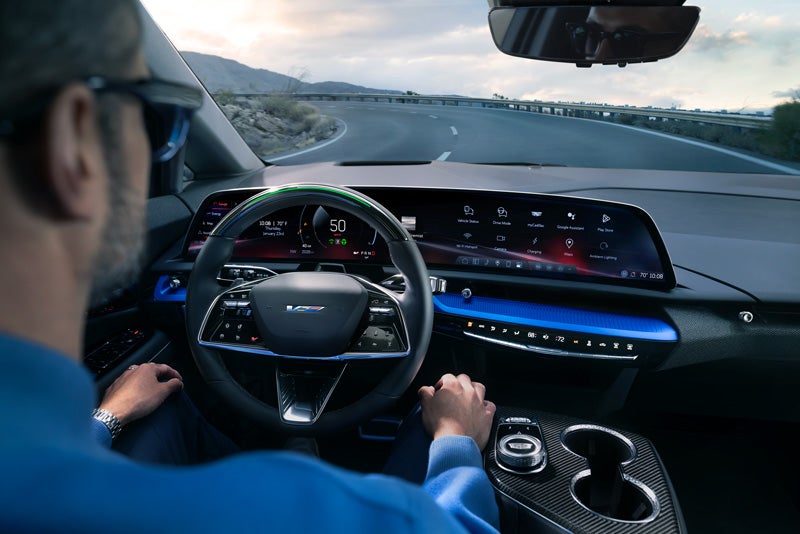 Front View of the 2026 OPTIQ-V Driving Through the Dusk Utilizing its Headlights | Reliable Cadillac in Roseville CA